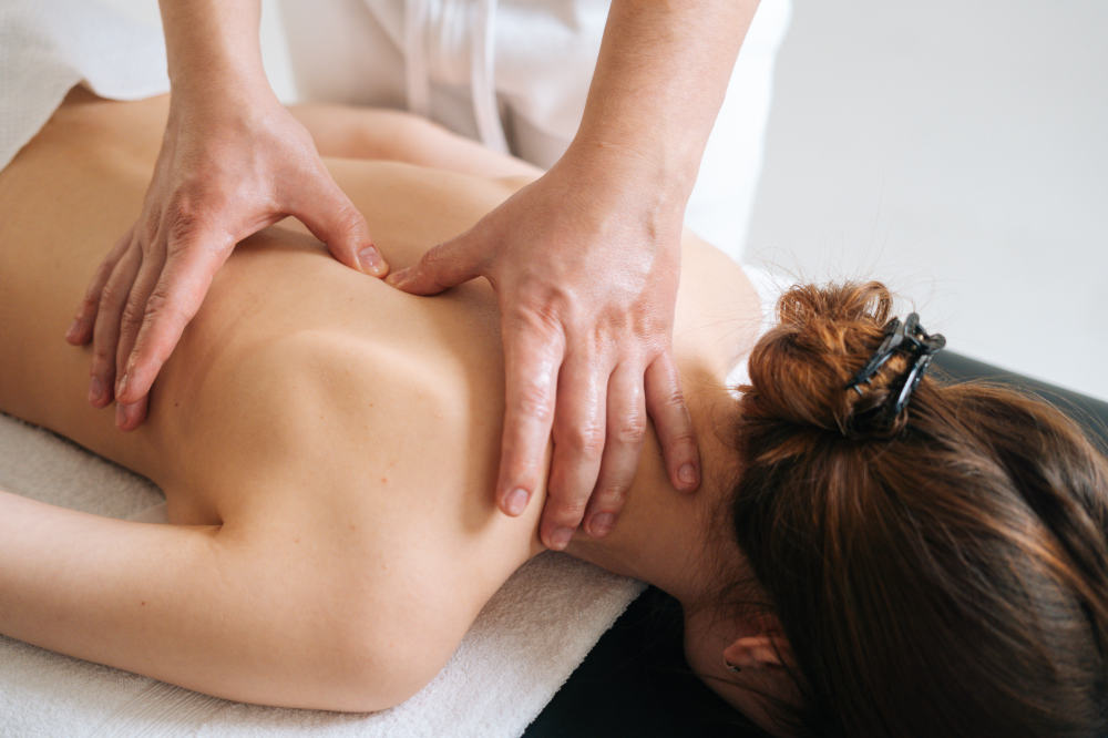 Massage in Physiotherapie Aim Praxis in Dresden, Therapeut massiert Patientin auf dem Rücken